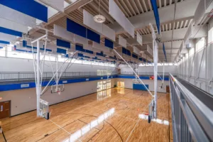 Indoor gymnasium with basketball courts looking down from second story