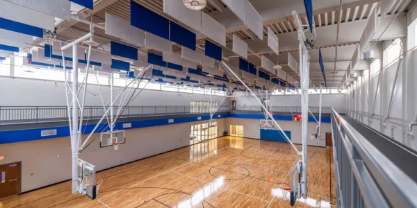 Indoor gymnasium with basketball courts looking down from second story