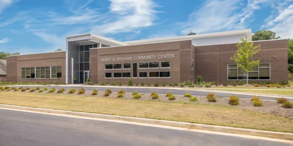 Henry Brigham Community Center exterior with a blue sky