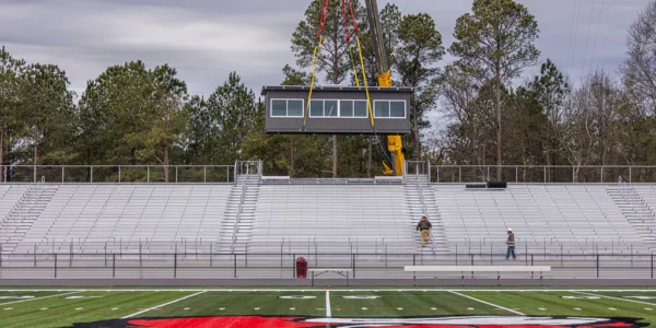 Placing a pressbox on a stadium via crane